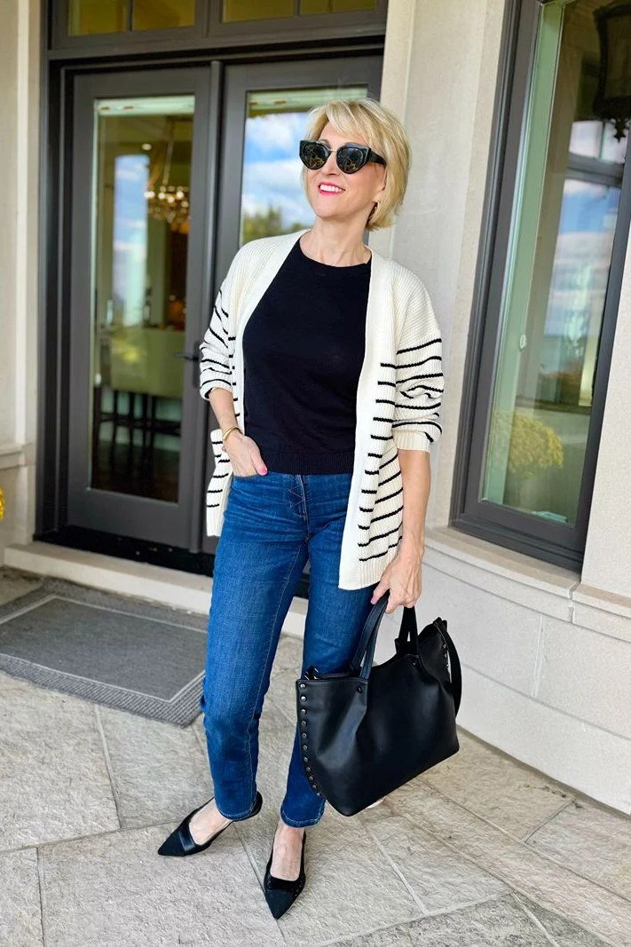 Striped cardigan with black top and dark jeans, trendy casual outfit for women over 40