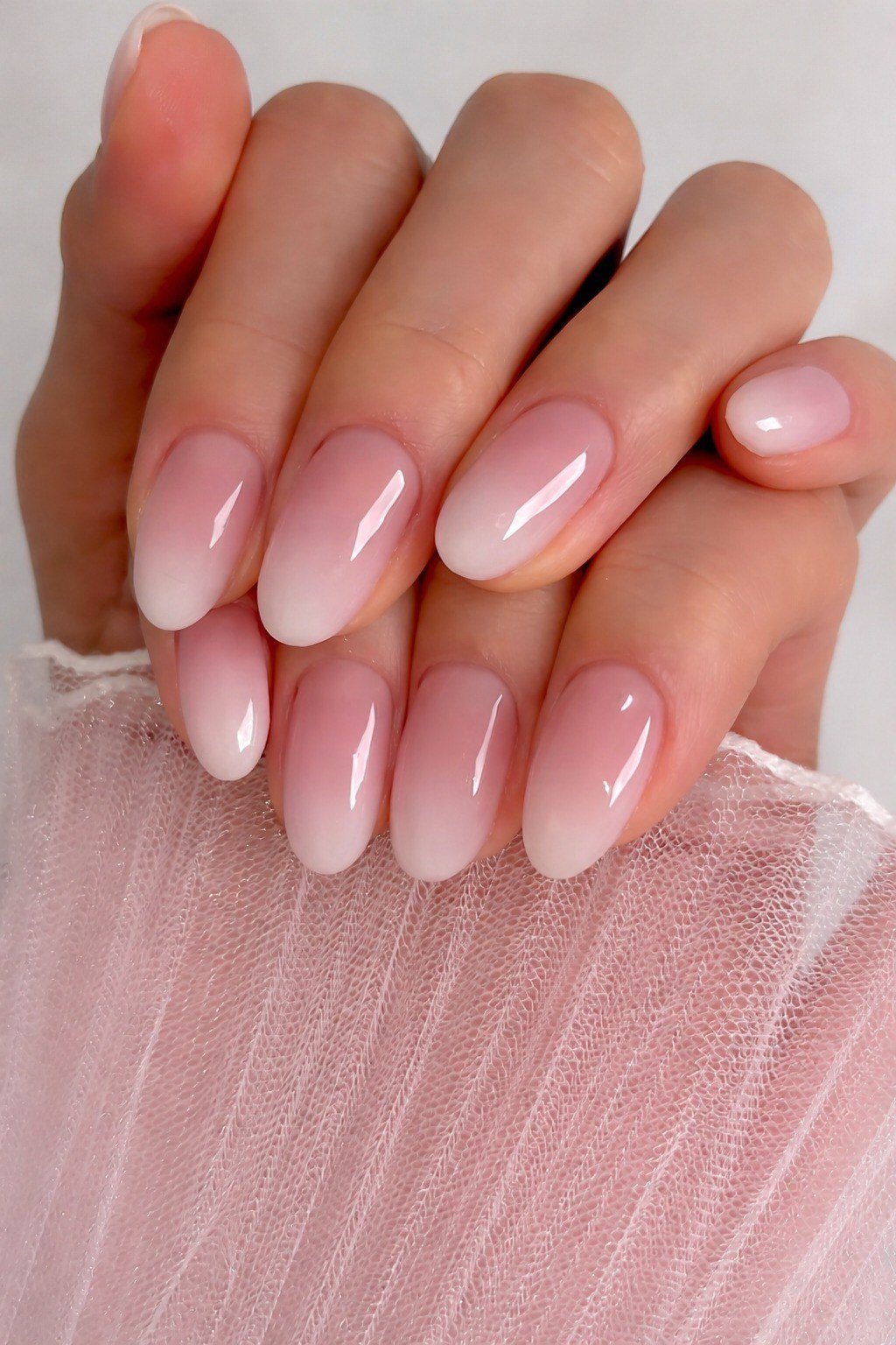 soft pink ombre almond nails with glossy finish