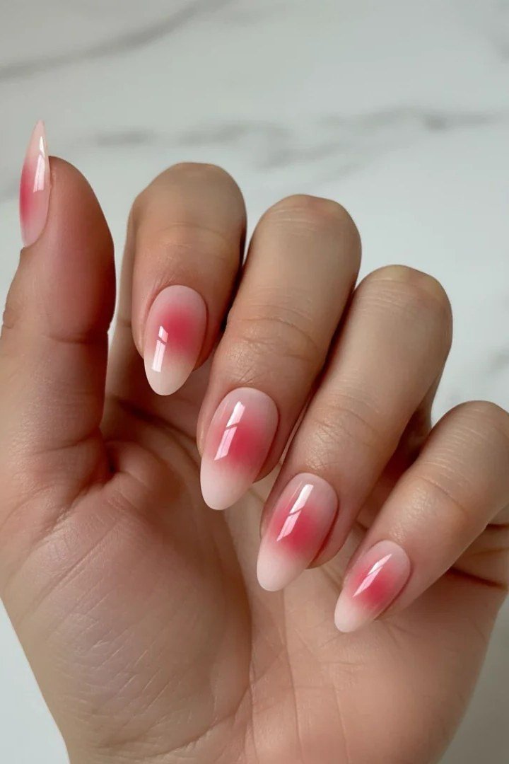 Sheer pinky-red glazed ombre almond nails