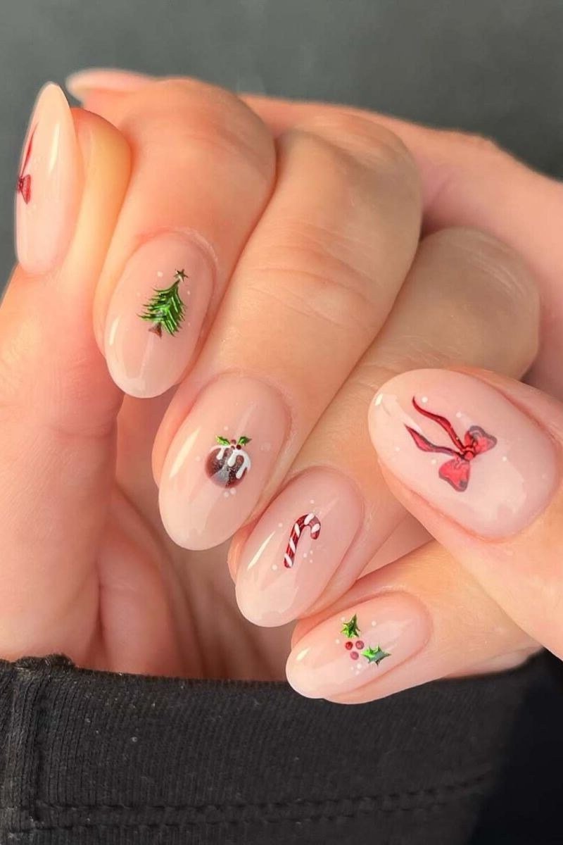 Sheer nude nails with red bow and tiny Christmas motifs - classy Christmas nail idea for women over 70