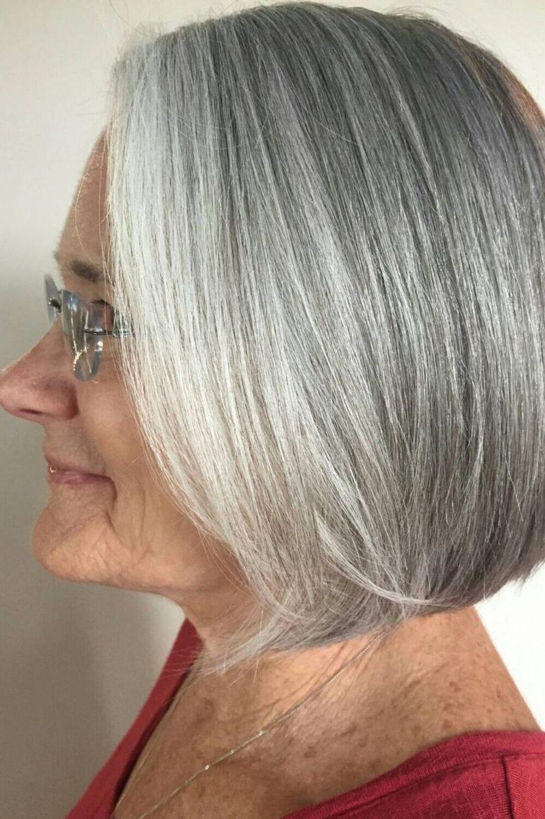 Classic chin-length silver bob on an older woman, side view, medium hairstyle for women over 60