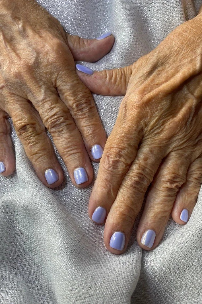 light purple short nails on aged hands