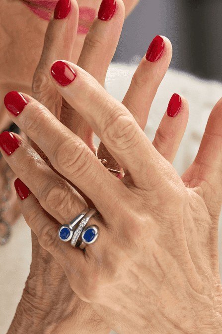 classic red nail polish on mature hands over 50