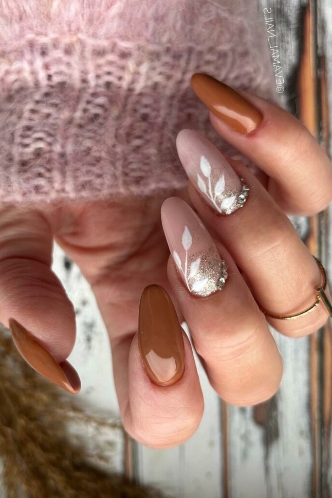 Caramel Brown Almond Nails with White Leaf Accents, fall nail color idea for women over 50