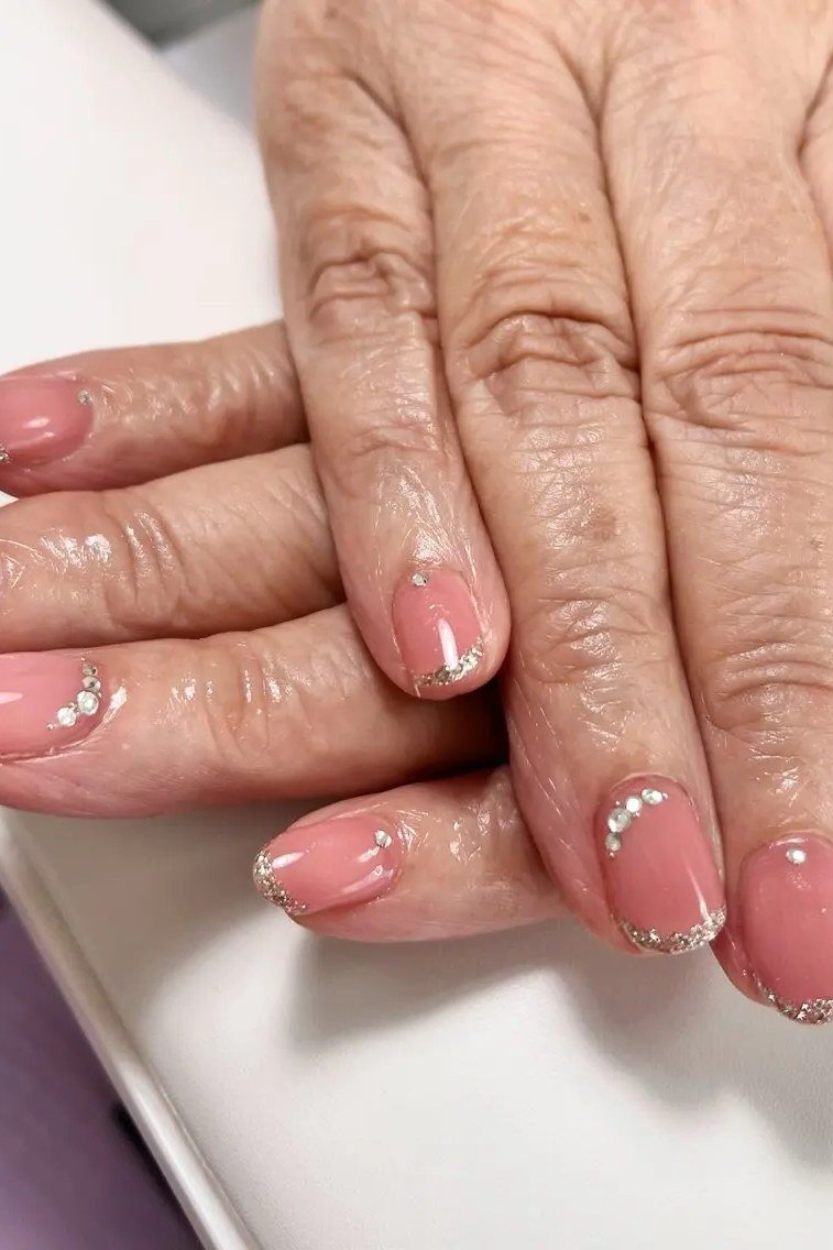 Pink Glitter French on Mature Hands nail design for women over 40