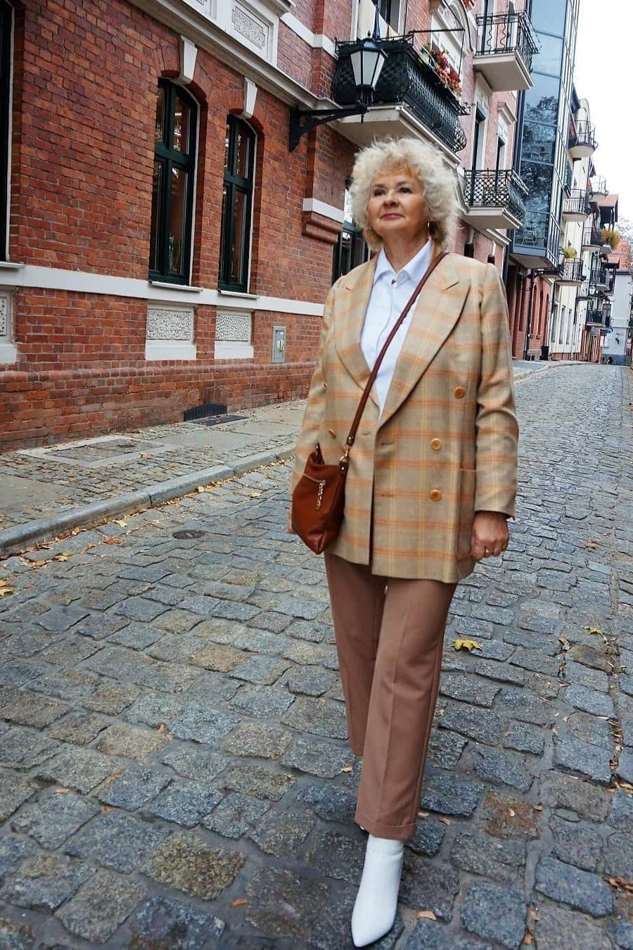 Tan plaid blazer with tan trousers fall outfit idea for women over 60