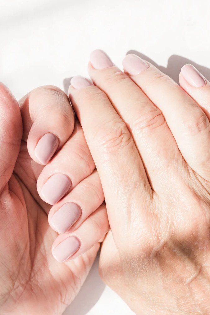 Mature hands with creamy mauve nail polish
