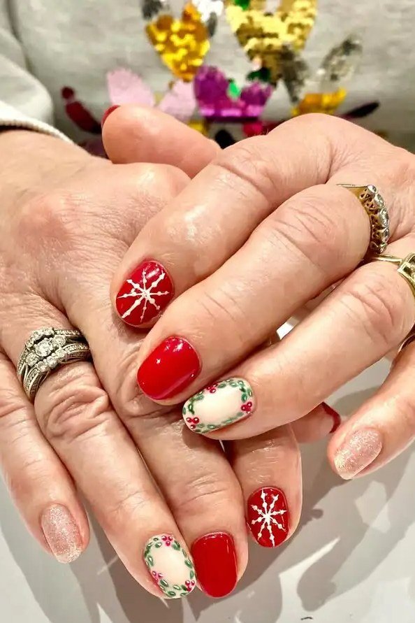 Red polish with red/green Christmas accents, older hands with rings - Christmas nail design for older women