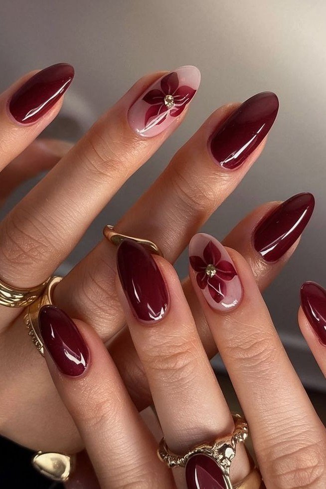 Deep burgundy stiletto nails with sheer floral accent for women over 50