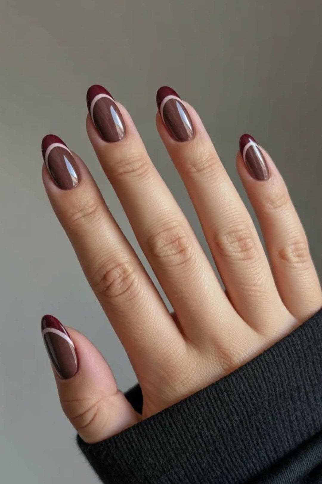 Dark burgundy short almond gel nails with glossy finish, fall nail color for older women