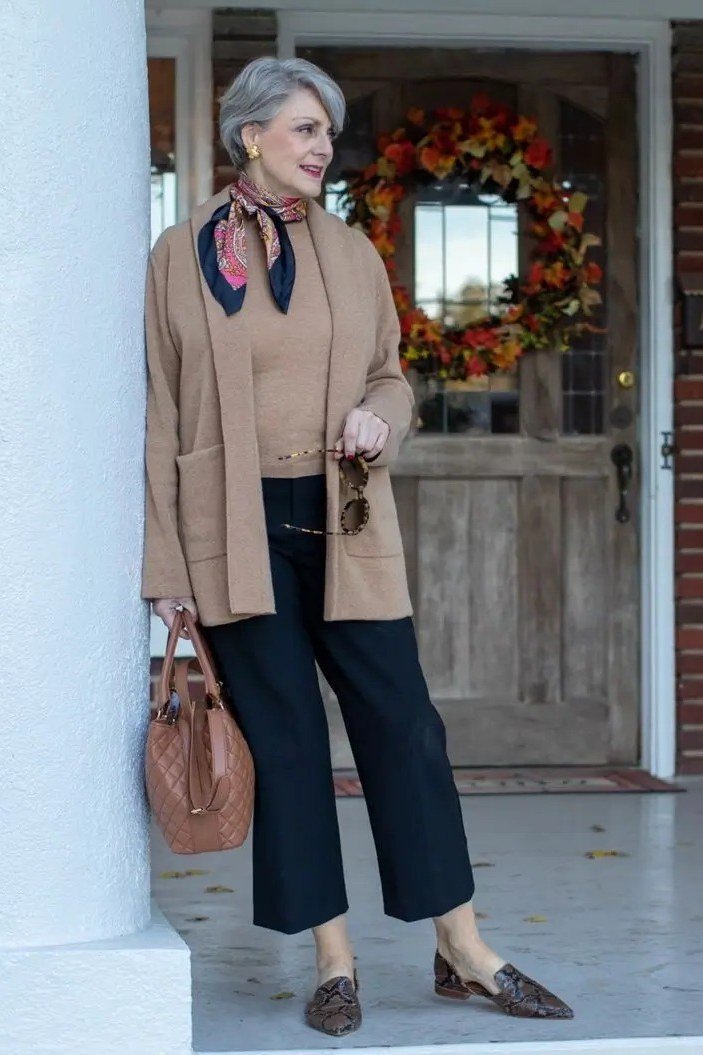 Camel blazer with black wide-leg trousers and printed scarf for women over 60