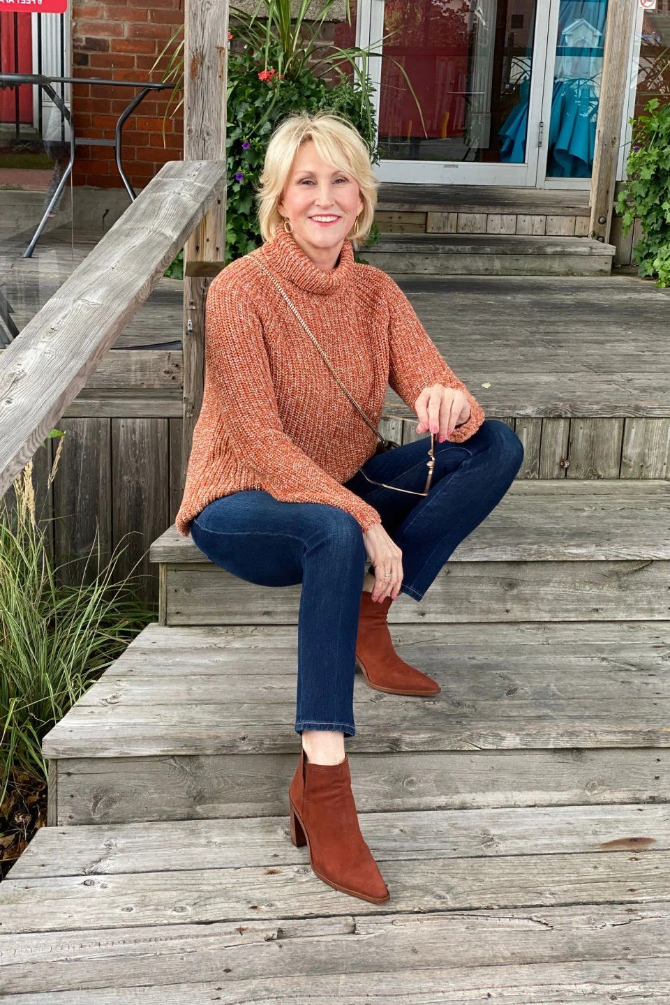 Rust turtleneck dark jeans ankle boots rust turtleneck sweater dark jeans brown boots blonde - fall outfit idea for women over 40
