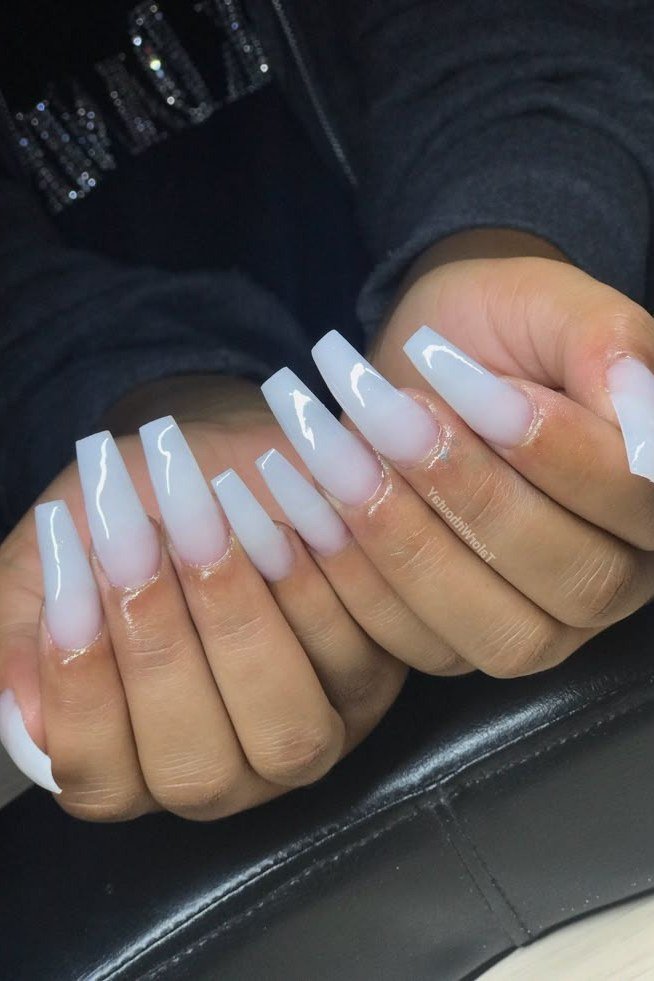 Sheer milky white polish on short natural nails of older hands