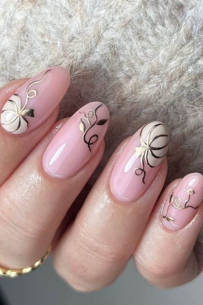 2. Soft Pink Nails With White Pumpkin Line Art - Thanksgiving nail art idea for women over 50