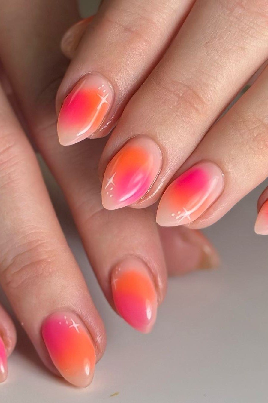 Coral-pink translucent ombre almond nails