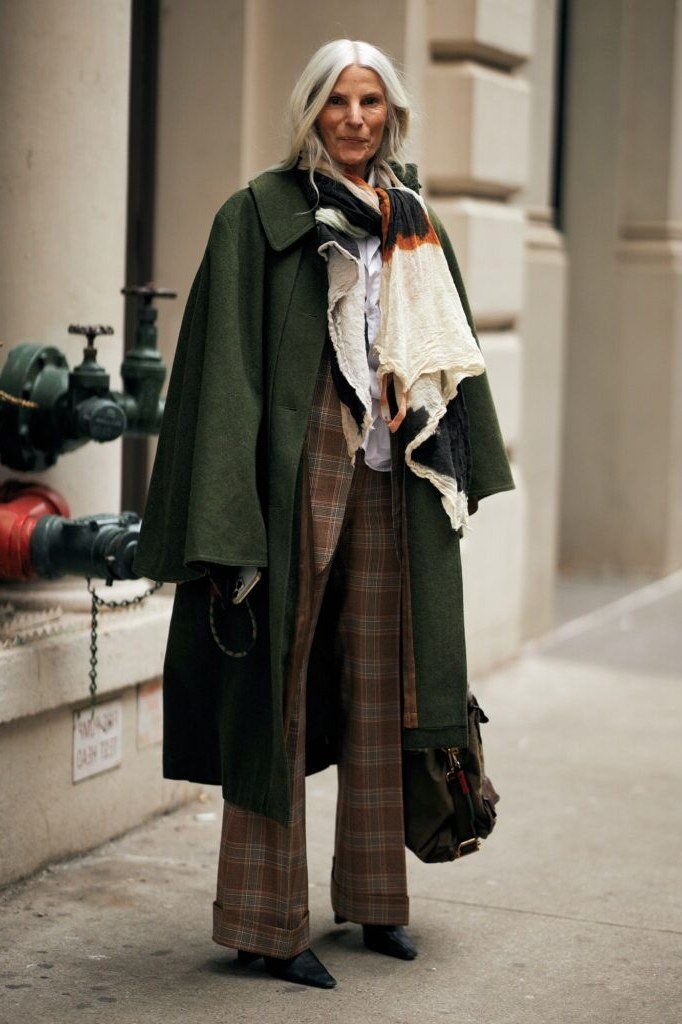 Elegant fall outfit for women over 70: forest green coat with plaid and scarf