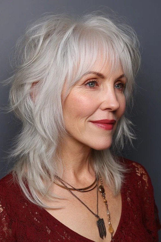 White layered shag haircut with soft fringe for older women