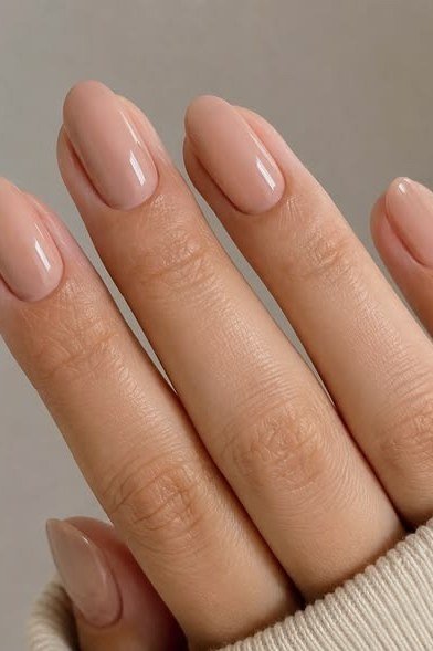 Soft nude manicure with cream sweater sleeve
