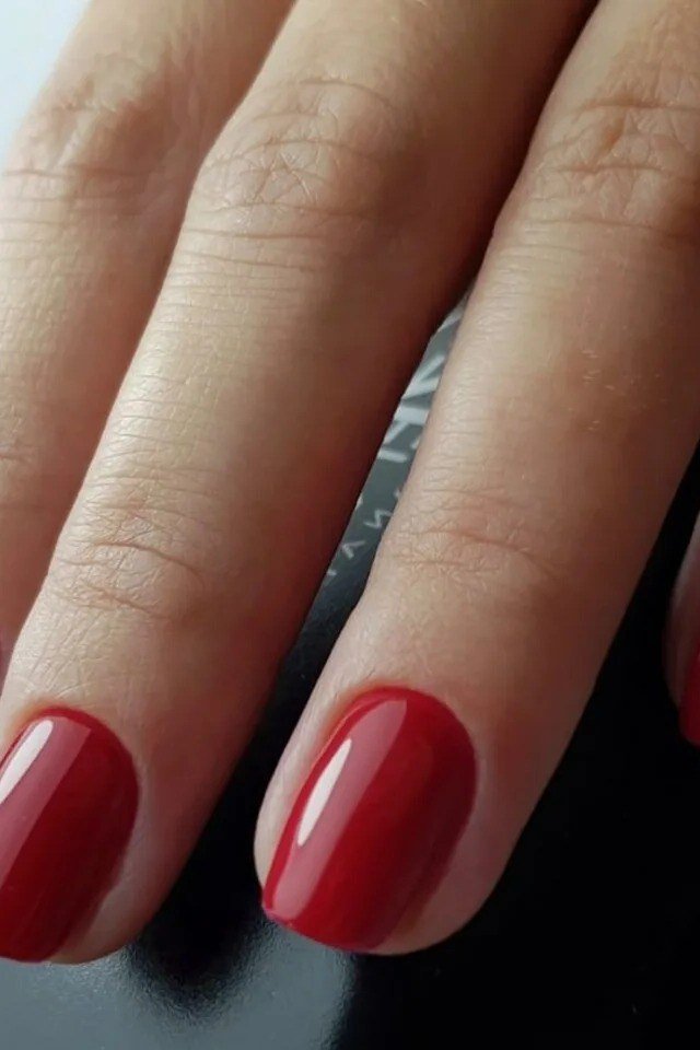 Deep red glossy nails closeup
