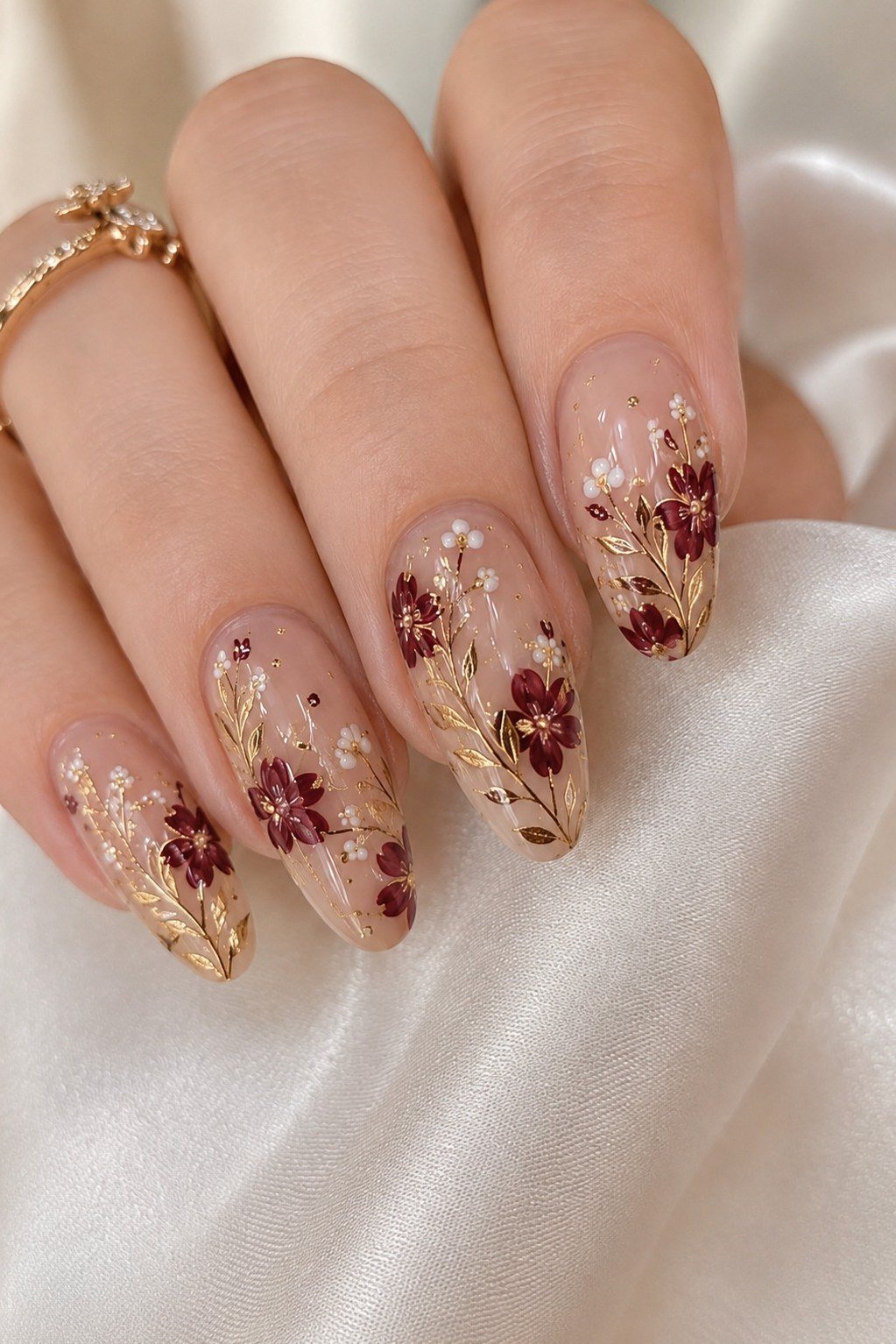 Sheer nude nails with burgundy floral nail art for women over 50