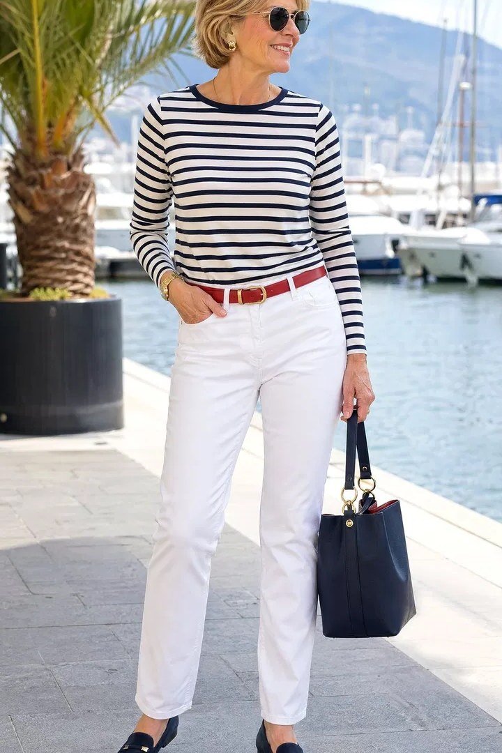 Navy striped tee with white jeans and red belt for women over 50