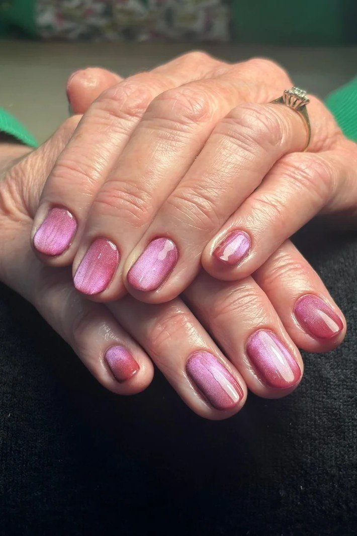 Mauve pink metallic nails on mature hands