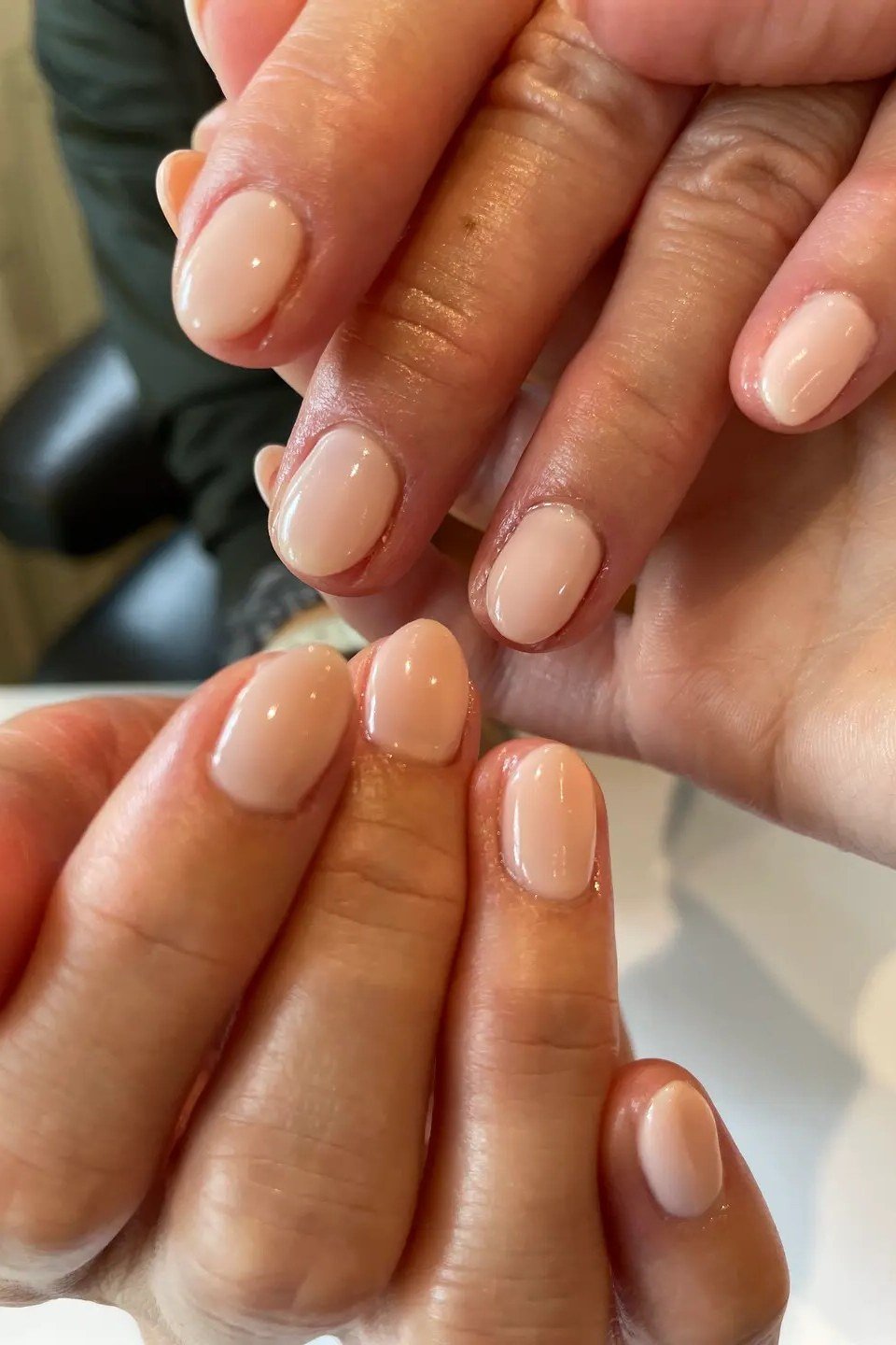 Warm Beige Short Nails, Hands Crossed - short nude nail idea for women over 50