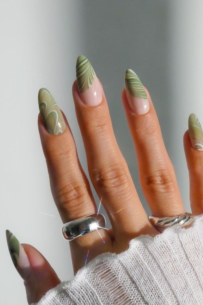 Nail art design for women over 60: green swirl marble almond nails