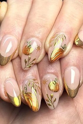 3. Gold Pumpkin and Leaf Art on Nude Almond Nails - Thanksgiving nail art idea for women over 50