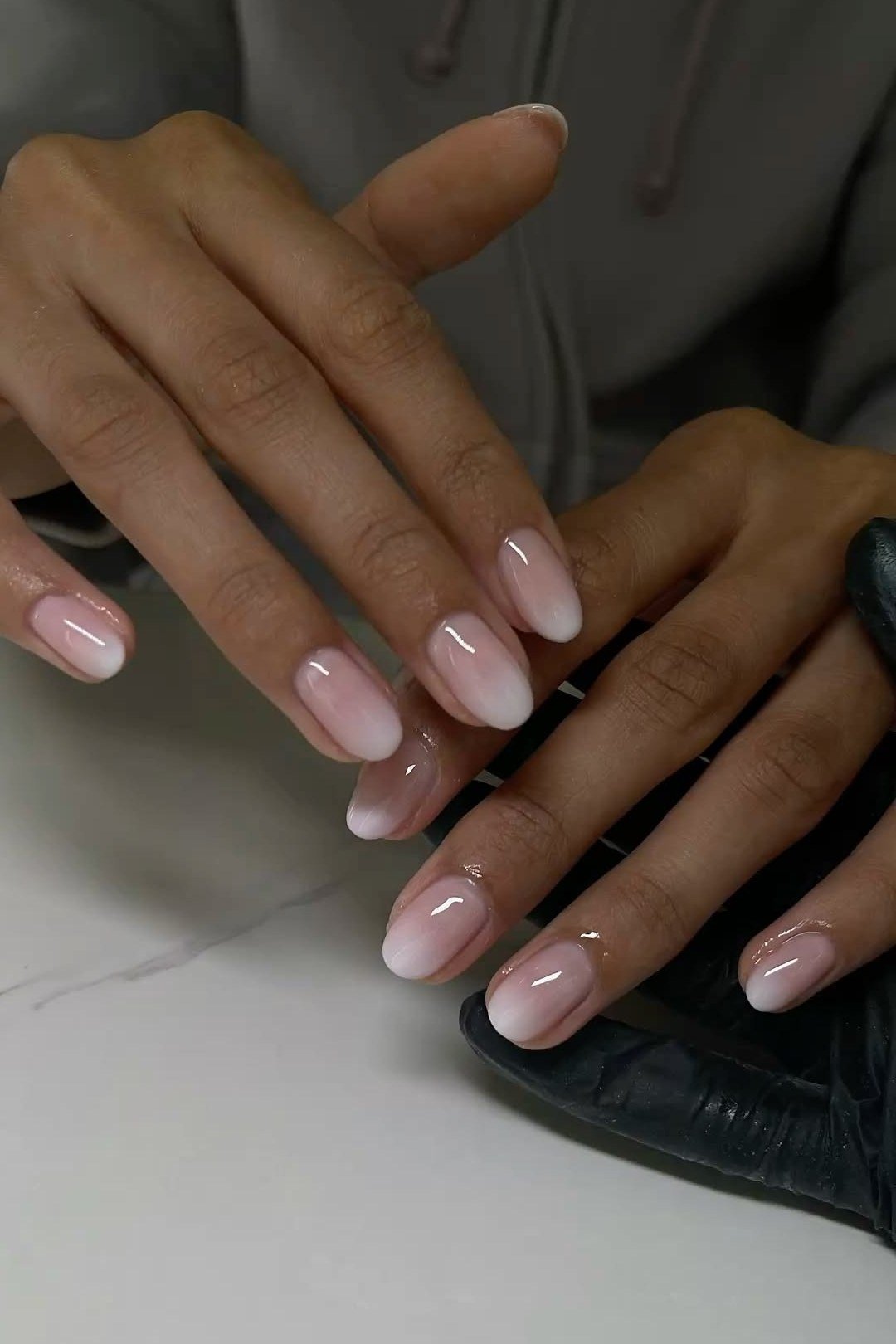 pink white baby boomer ombre on long almond nails mature hands