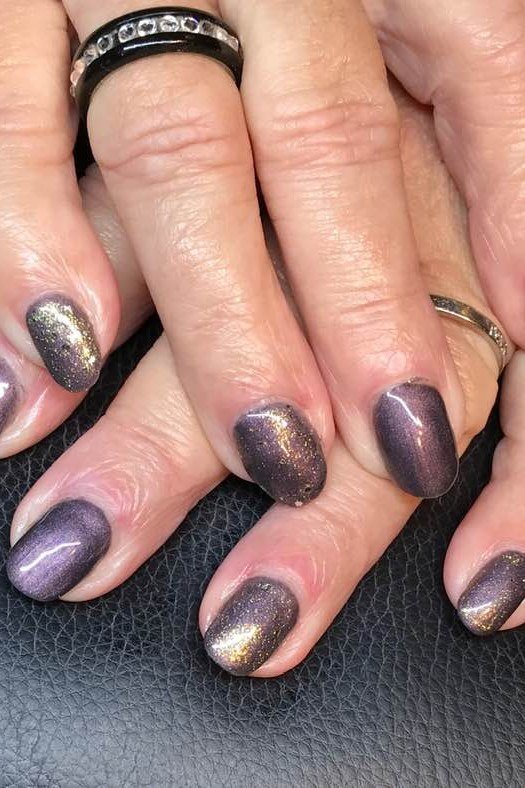 Plum Cat Eye Nails - Rich plum polish with golden shimmer forms these elegant cat eye nails.