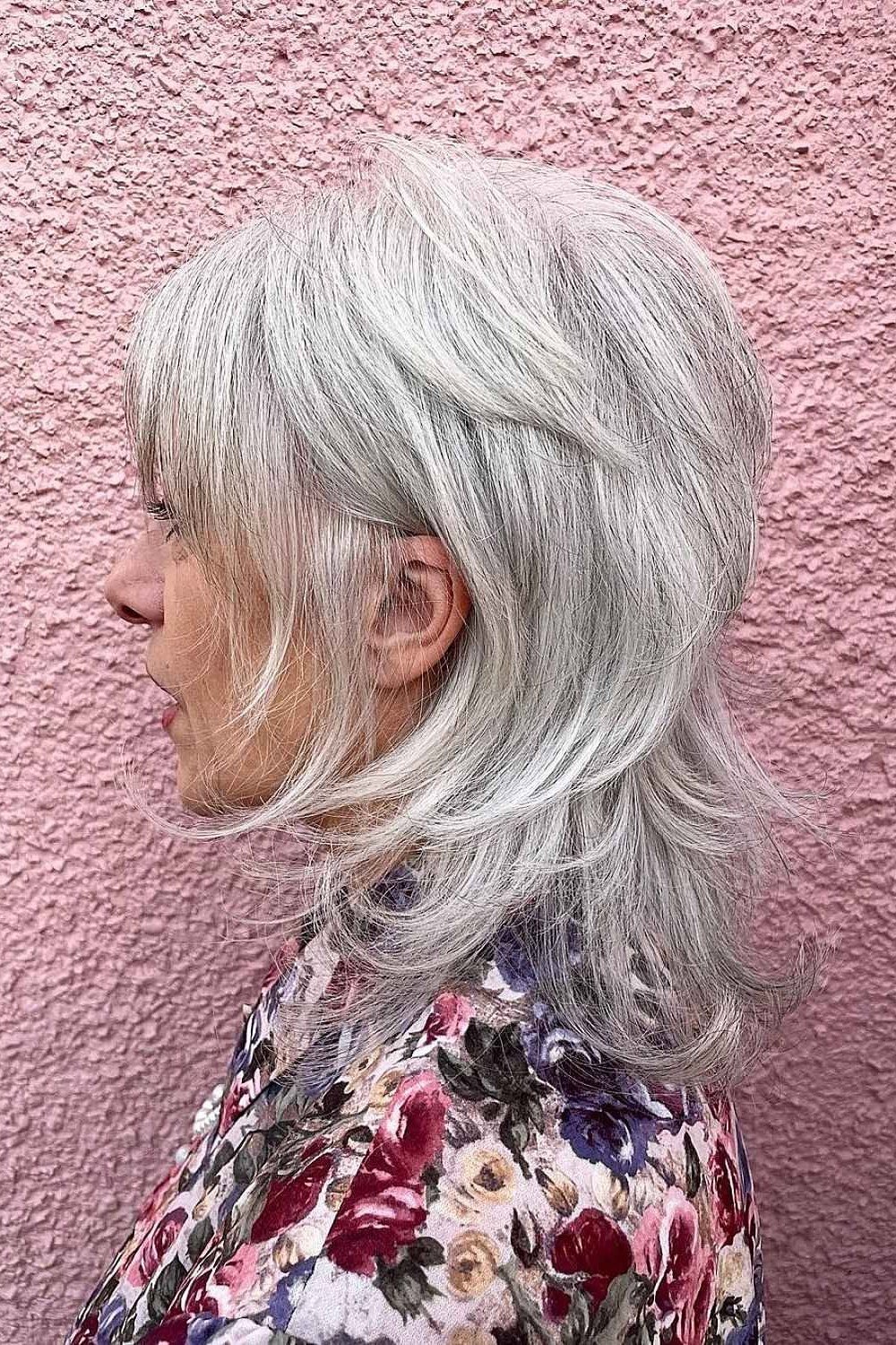 Silver shaggy haircut with choppy layers side view over 60