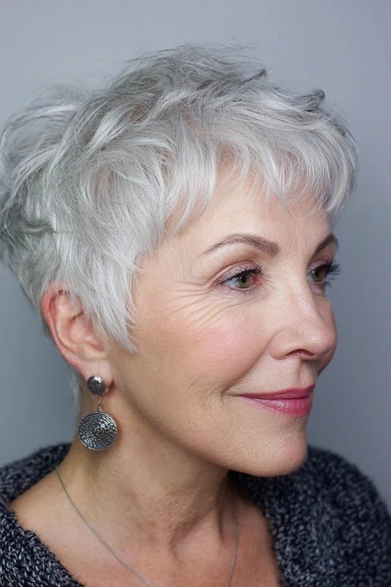 Silver pixie with piecey fringe, side view, micro pixie cut for women over 60 going silver