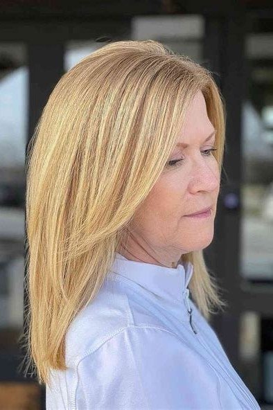 blonde very long straight hairstyle, side view, center part for women over 50
