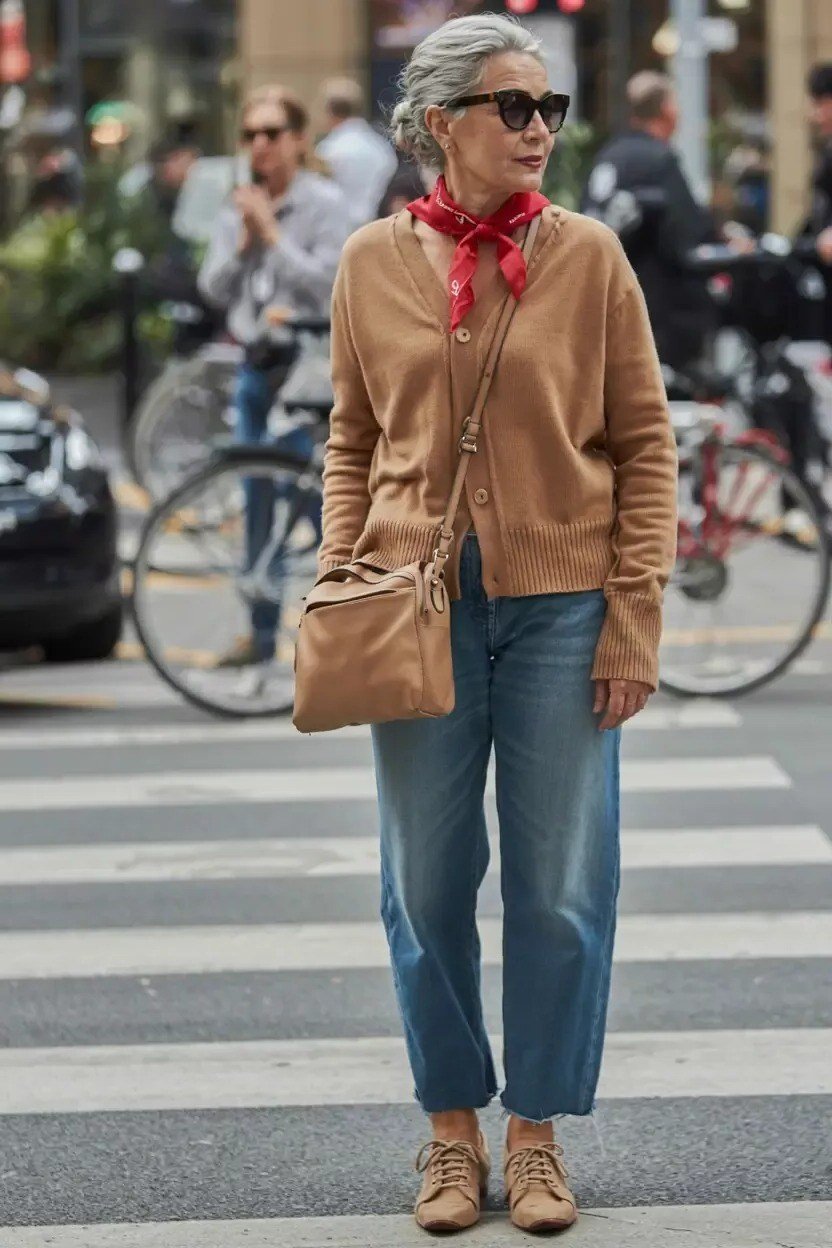 Casual fall outfit for women over 60: white half-zip sweater, white jogger pants, white sneakers, outdoor brick wall