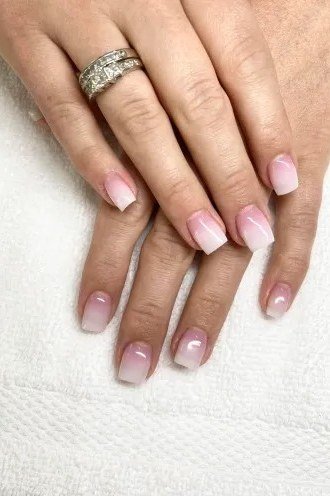 Pink nude ombre on mature hands, medium oval nails, glossy, ombre nail design for women over 60