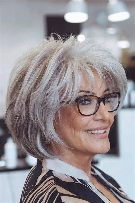 shaggy silver bob with bangs and glasses, 3/4 view, medium length hairstyle for women over 60