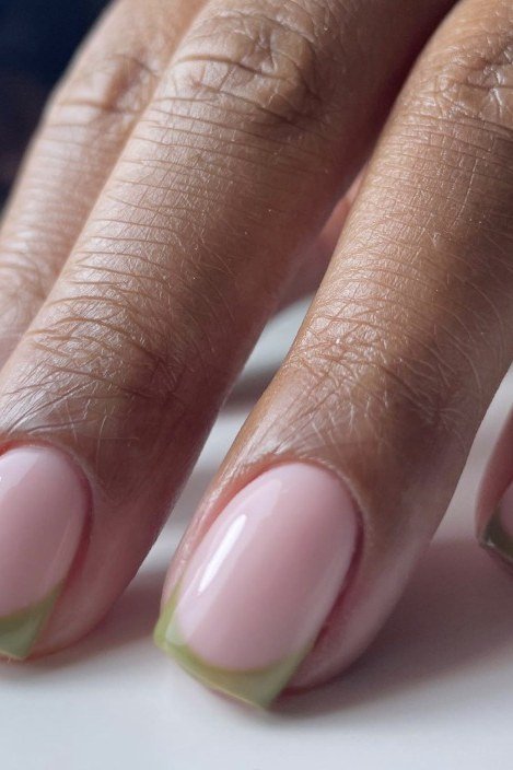 Pale pink gel nails with sage green French tips on dark skin, fall French tip design