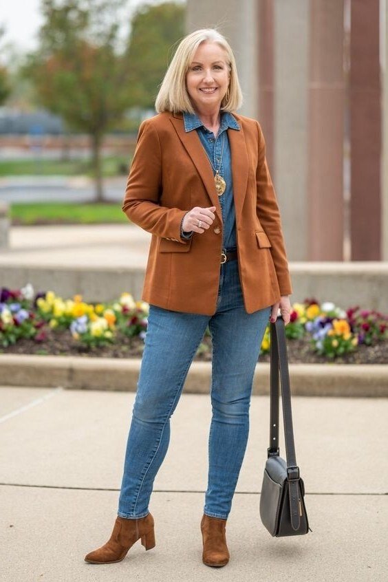 Rust blazer over denim shirt with jeans and brown ankle boots for older women