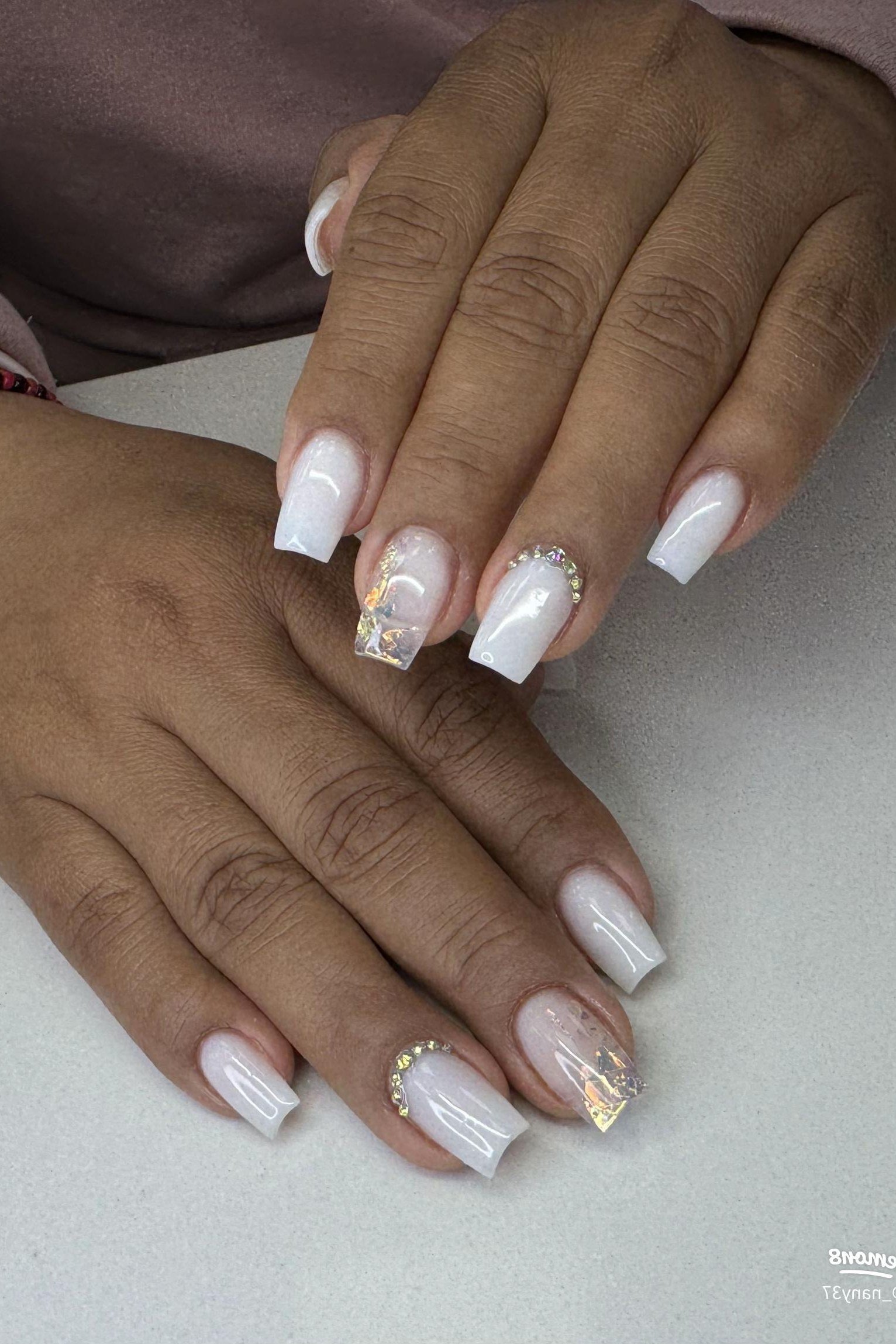 Milky white nails with small pearl accents on dark skin