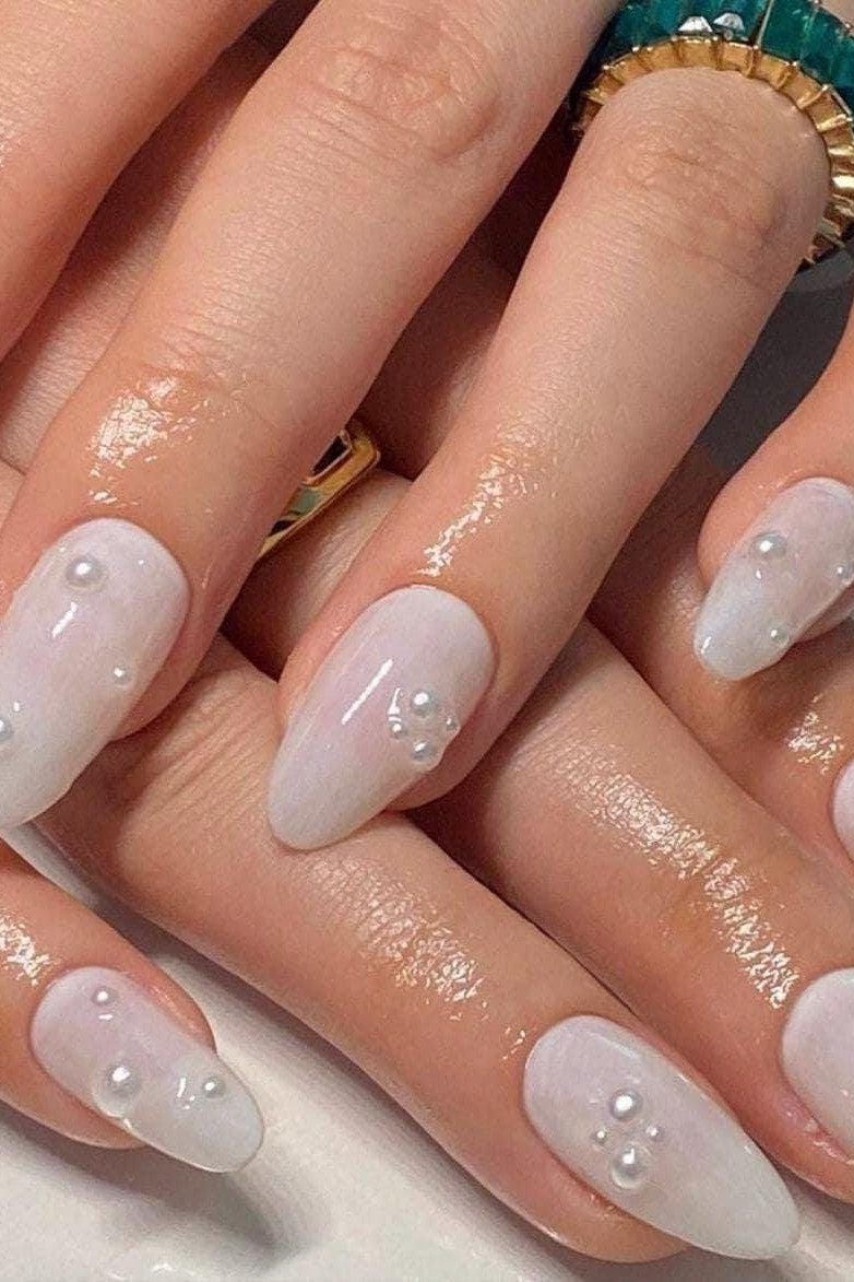 Milky White Almond Nails with Scattered Pearls - pearl finish nail idea for women over 60