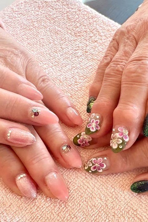 Green nails with glitter floral art for older women