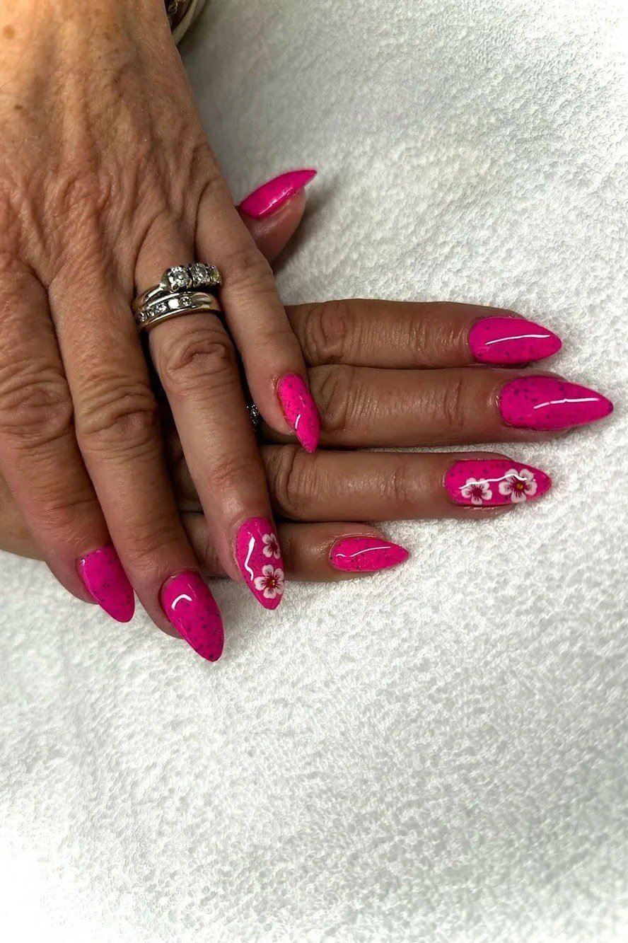 Hot Pink Almond Gel Nails with Floral Art - short gel nail idea for women over 50