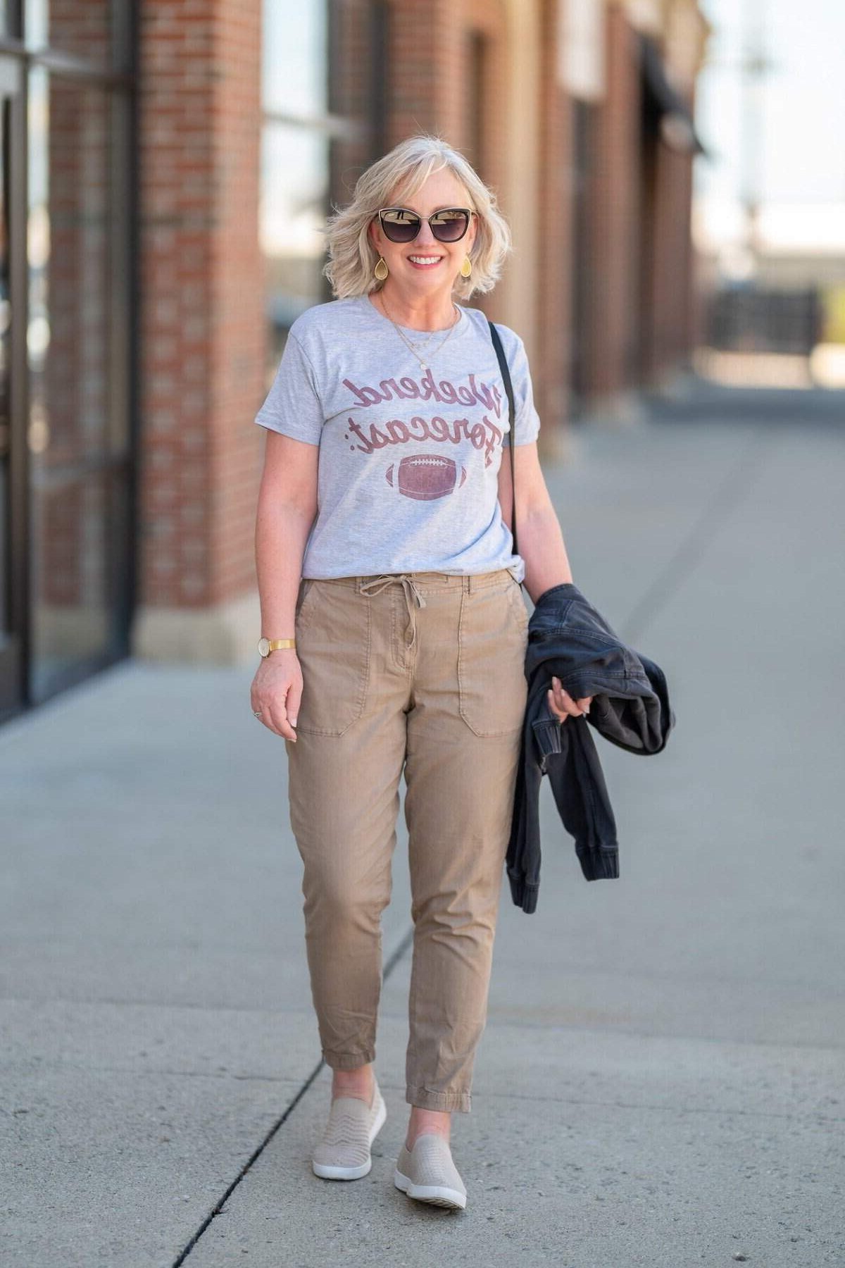 Grey graphic tee with khaki cargo joggers and white sneakers, relaxed weekend outfit for women over 40