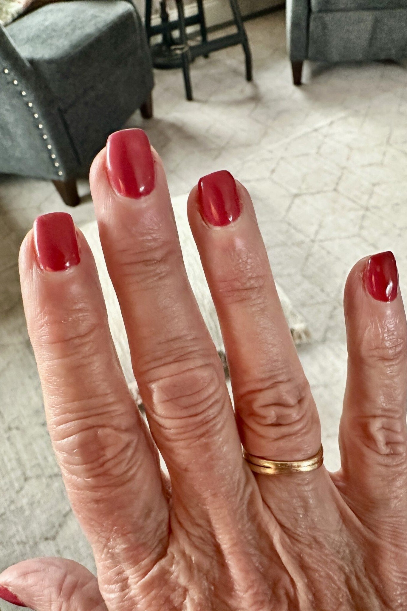 Cherry red nails on mature hand