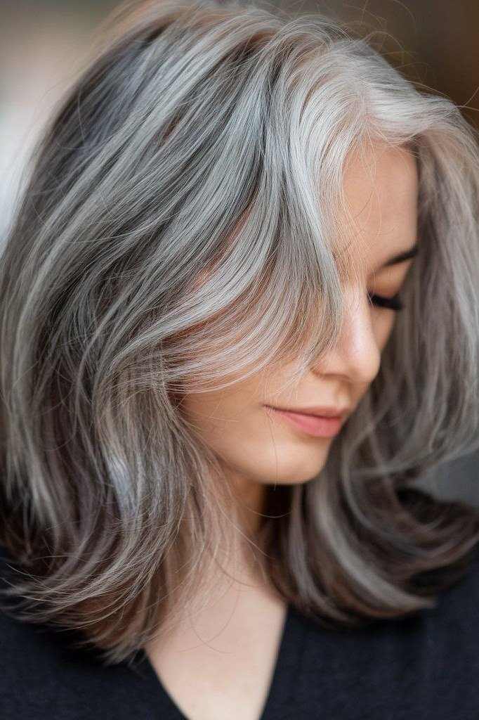 Polished silver lob with curtain bangs for women over 40