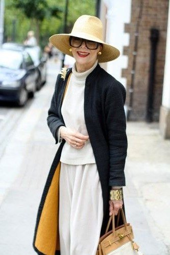 Black long coat with white top and white wide-leg trousers for women over 50