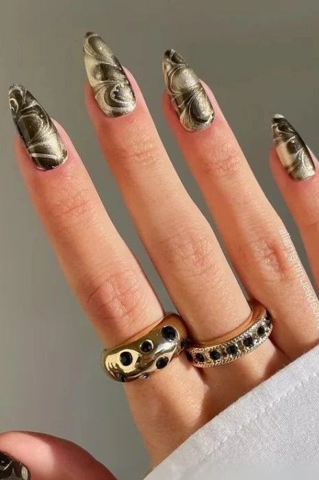 Nail art design for women over 60: metallic gold and black marble long nails