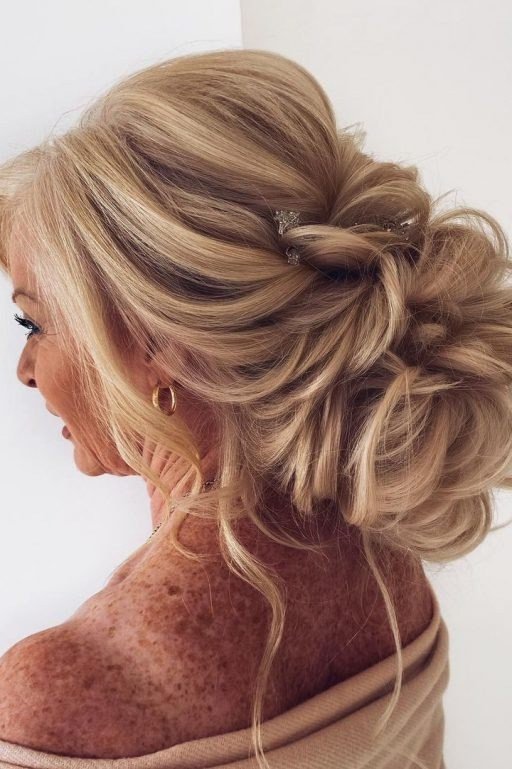 Elegant long blonde messy bun updo for women over 50