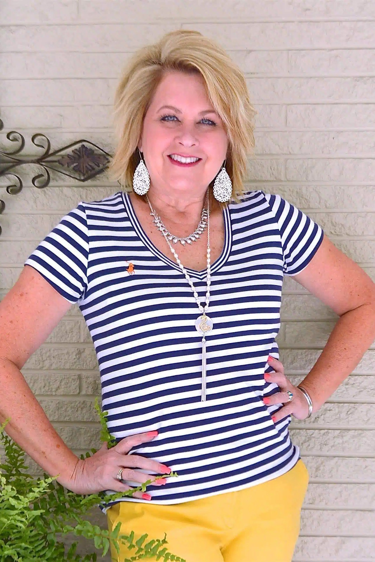 Woman over 50 wearing striped tee with mustard pants, everyday casual outfit idea